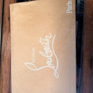 Christian Louboutin Pumps with Beige Box for storage.